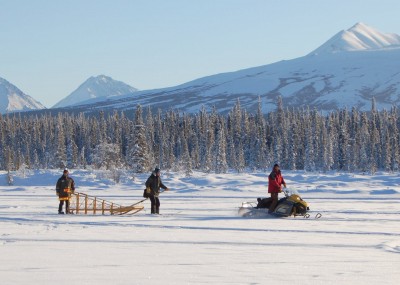 Jeff rides the sled, Tracey is skiing and figuring out the gee-pole, while Tyler pulls them in circles around the lake.