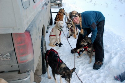 Christy Berington takes a moment to smile for the camera while harnessing dogs at the race start.