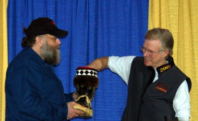 Race Marshall Mark Nordman holds the mukluk that the musher's draw their bib number from. Jeff picked bib #11.